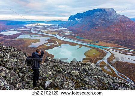 Photographer taking picture on the view from mount Namatj over the Laitaure delta in Sarek national park in sweden, swedish lapland in the month of september. View Large Photo Image Stock Image - Photographer taking picture on the view from mount Namatj over the Laitaure delta in Sarek national park in sweden, swedish lapland in the month of september.. Fotosearch