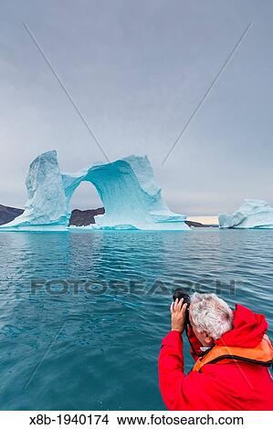 Photographer with huge icebergs in Scoresbysund, Northeast Greenland View Large Photo Image Picture - Photographer with huge icebergs in Scoresbysund, Northeast Greenland. Fotosearch