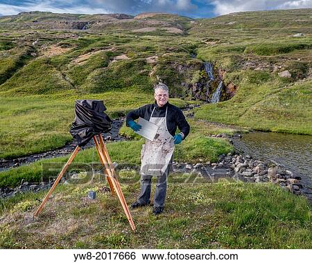 Stock Photograph - Photographer with old camera, using the technique of the collodion process, Iceland.. Fotosearch