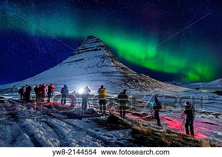 Picture - Photographing Kirkjufell (Church Mountain) with the Auroras in Grundarfjordur, on the north side of Snaefellsnes Peninsula, Iceland.. Fotosearch