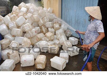Phu Quoc (Vietnam): a man washing jerry cans for fish sauce in factory of Duong Dong View Large Photo Image Stock Image - Phu Quoc (Vietnam): a man washing jerry cans for fish sauce in factory of Duong Dong. Fotosearch
