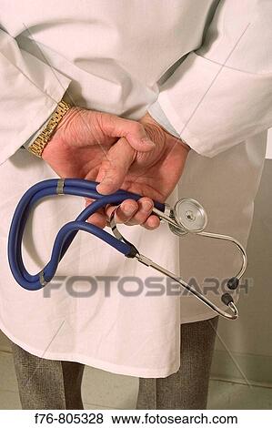 Stock Photo - Physician, holding stethoscope in hands behind his back. Fotosearch