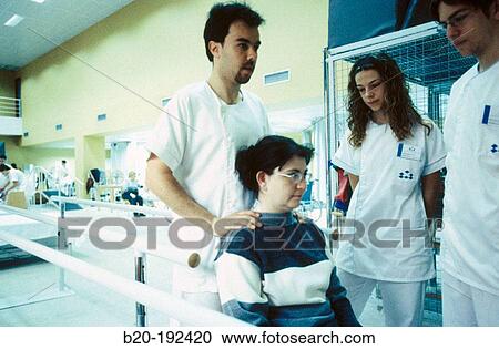 Stock Image - Physiotherapists at hospital rehabilitation area. Fotosearch
