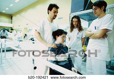 Stock Image - Physiotherapists at hospital rehabilitation area. Fotosearch