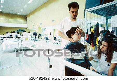Stock Image - Physiotherapists at hospital rehabilitation area. Fotosearch