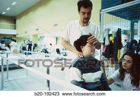 Stock Image - Physiotherapists at hospital rehabilitation area. Fotosearch