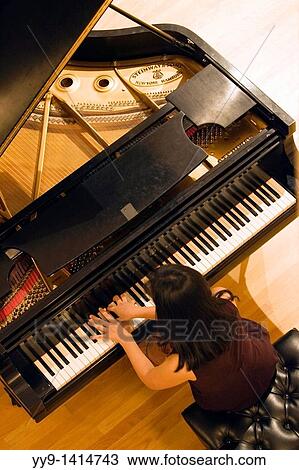 Pianist playing piano in concert View Large Photo Image Stock Image - Pianist playing piano in concert. Fotosearch