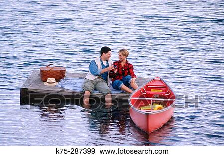 Stock Photo - picnic on a floating dock in lake. Fotosearch