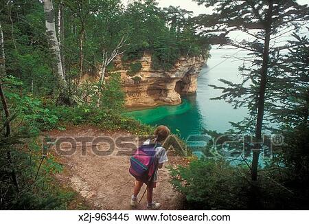 Pictured Rocks National Lakeshore, Michigan - Mariel West, 7, looks at some of the cliffs in Pictured Rocks National Lakeshore while backpacking on the North Country Trail along Lake Superior MR View Large Photo Image Stock Photography - Pictured Rocks National Lakeshore, Michigan - Mariel West, 7, looks at some of the cliffs in Pictured Rocks National Lakeshore while backpacking on the North Country Trail along Lake Superior MR. Fotosearch