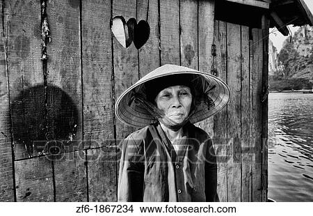 Picturesque scene old woman in purple in fishing village in Halong Bay Ha Long relax Vietnam View Large Photo Image Picture - Picturesque scene old woman in purple in fishing village in Halong Bay Ha Long relax Vietnam. Fotosearch