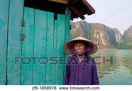 Picturesque scene old woman in purple in fishing village in Halong Bay Ha Long relax Vietnam View Large Photo Image Stock Photo - Picturesque scene old woman in purple in fishing village in Halong Bay Ha Long relax Vietnam. Fotosearch