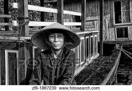 Picturesque scene old woman in purple in fishing village Halong Bay Ha Long relax Vietnam View Large Photo Image Stock Photo - Picturesque scene old woman in purple in fishing village Halong Bay Ha Long relax Vietnam. Fotosearch