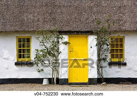 Picturesque thatched cottage with yellow door and windows in Ballyvaughan, Ireland, Europe View Large Photo Image Stock Image - Picturesque thatched cottage with yellow door and windows in Ballyvaughan, Ireland, Europe. Fotosearch