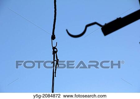 piece of string hanging from a hook against blue sky View Large Photo Image Stock Image - piece of string hanging from a hook against blue sky. Fotosearch