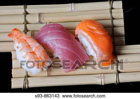 Pieces of shrimp, tuna and salmon sushi on a plate made of bamboo tied together making a serving tray. View Large Photo Image Stock Image - Pieces of shrimp, tuna and salmon sushi on a plate made of bamboo tied together making a serving tray.. Fotosearch