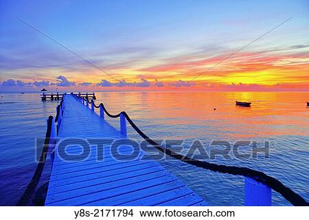 Picture - Pier at sunrise at Odyssee Resort and Spa at Zarzis, Tunisia, Tunisia.. Fotosearch