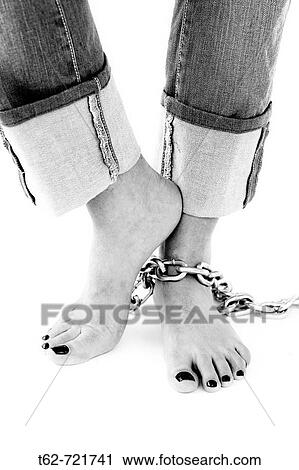 Pies de mujer con cadenas View Large Photo Image Stock Image - Pies de mujer con cadenas. Fotosearch