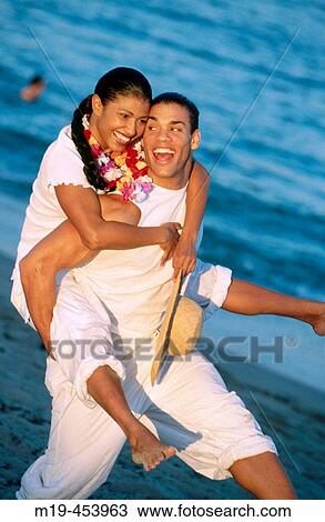 piggy back ride on the beach View Large Photo Image Stock Image - piggy back ride on the beach. Fotosearch
