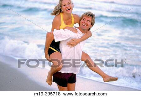 piggy back ride on the beach View Large Photo Image Stock Photo - piggy back ride on the beach. Fotosearch