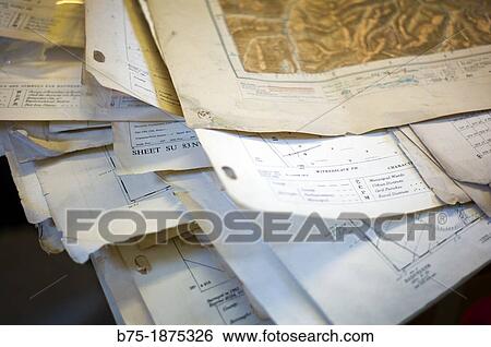 pile of maps and documents on top of a table View Large Photo Image Stock Photograph - pile of maps and documents on top of a table. Fotosearch