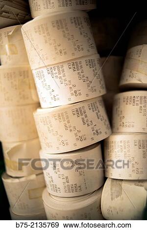 Stock Photo - Piles of rolls of a book shop register machine with prices of diferent concepts and press, Menorca, Balearics, Spain, Europe.. Fotosearch