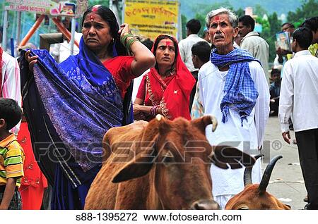 Stock Image - Pilgrim couple at Lakshman Jhula in Rishikesh. Fotosearch