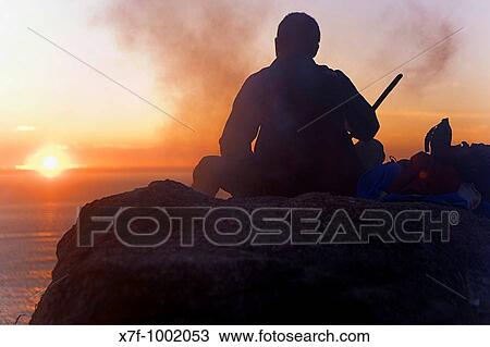pilgrim enjoying a sunset in Cape Finisterre and burning the clothes used during the peregrination to Santiago de Compostela Finisterre Corua province Spain Camino de Santiago View Large Photo Image Stock Image - pilgrim enjoying a sunset in Cape Finisterre and burning the clothes used during the peregrination to Santiago de Compostela Finisterre Corua province Spain Camino de Santiago. Fotosearch