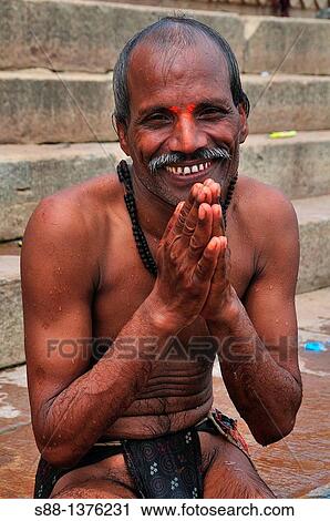 Pilgrim man at the ghat by the Ganges river View Large Photo Image Stock Image - Pilgrim man at the ghat by the Ganges river. Fotosearch