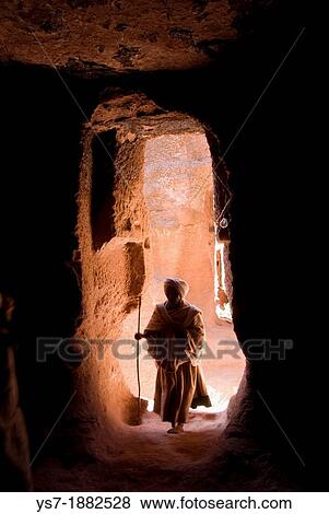 Pilgrim walking through a narrow passage to reach the entrance of Bet Amanuel monolithic rock-cut church in Lalibela, Ethiopia, Africa View Large Photo Image Stock Photo - Pilgrim walking through a narrow passage to reach the entrance of Bet Amanuel monolithic rock-cut church in Lalibela, Ethiopia, Africa. Fotosearch