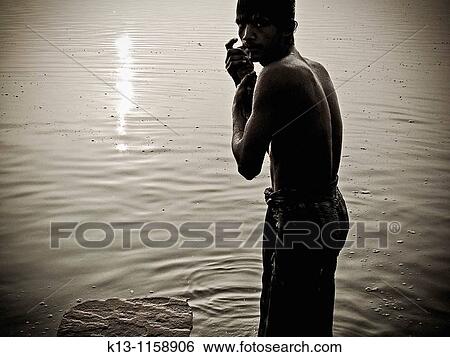 Pilgrims bathing at ghat steps on river Ganges Gats in Varanasi banaras Uttar Pradesh India View Large Photo Image Stock Photograph - Pilgrims bathing at ghat steps on river Ganges Gats in Varanasi banaras Uttar Pradesh India. Fotosearch