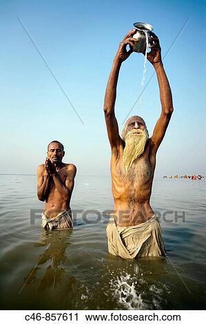Pilgrims bathing at the confluence of the river Ganges and the Bay of Bengal. Sagar Mela. Ganges River. India. View Large Photo Image Stock Image - Pilgrims bathing at the confluence of the river Ganges and the Bay of Bengal. Sagar Mela. Ganges River. India.. Fotosearch