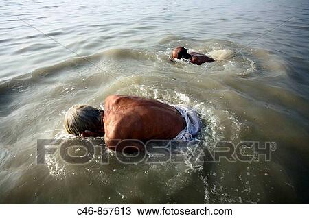 Pilgrims bathing at the confluence of the river Ganges and the Bay of Bengal. Sagar Mela. Ganges River. India. View Large Photo Image Stock Image - Pilgrims bathing at the confluence of the river Ganges and the Bay of Bengal. Sagar Mela. Ganges River. India.. Fotosearch