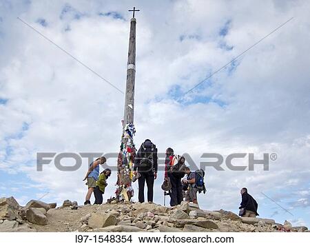 Picture - Pilgrims leaving stones at the base of Cruz de Ferro near the village of Foncebadon along the Camino de Santiago. Fotosearch