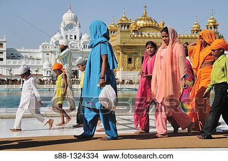 Picture - Pilgrims walking around Golden Temple by the holly lake, Punjab Amritsar India. Fotosearch