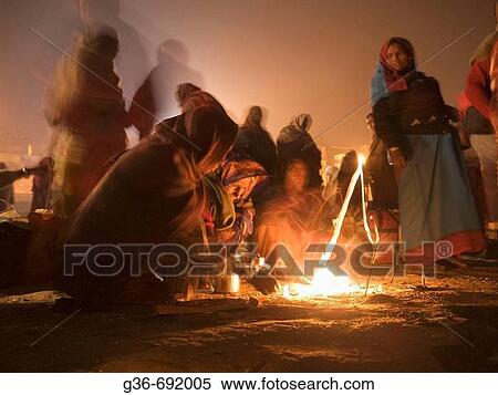 Pilgrims warm themselves by a fire near the holy river Ganges, an important pilgrimge site for Hindu? s, in Varanasi, Uttar Pradesh, India View Large Photo Image Stock Photography - Pilgrims warm themselves by a fire near the holy river Ganges, an important pilgrimge site for Hindu? s, in Varanasi, Uttar Pradesh, India. Fotosearch