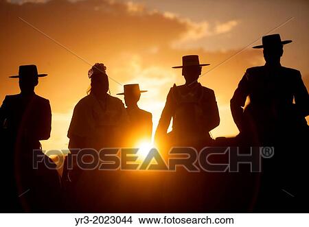 Pilgrims wearing Spanish hats ride their horses at sunset during the pilgrimage to the shrine of the Virgin of Rocio, in Almonte, Donana National Park, Huelva province, Andalusia, Spain View Large Photo Image Picture - Pilgrims wearing Spanish hats ride their horses at sunset during the pilgrimage to the shrine of the Virgin of Rocio, in Almonte, Donana National Park, Huelva province, Andalusia, Spain. Fotosearch