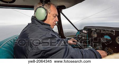 Stock Photography - Pilot in a small craft known as the Piper PA-23 Aztec, Grimsey Island, Iceland.. Fotosearch
