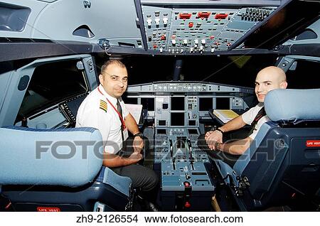 Pilots aircraft Airbus A-320 in the cockpit, airport Sharjah, Sharjah (emirate), UAE. View Large Photo Image Picture - Pilots aircraft Airbus A-320 in the cockpit, airport Sharjah, Sharjah (emirate), UAE.. Fotosearch