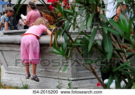 Pink clad child playing with water in Freiburg im Breisgau View Large Photo Image Stock Image - Pink clad child playing with water in Freiburg im Breisgau. Fotosearch