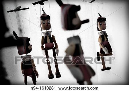 Pinocchio puppets made of wood, hanging in a window. View Large Photo Image Stock Image - Pinocchio puppets made of wood, hanging in a window.. Fotosearch
