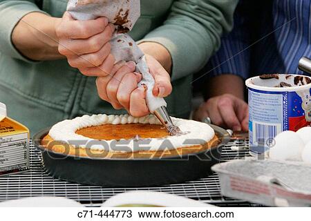 Piping icing on cake View Large Photo Image Stock Image - Piping icing on cake. Fotosearch