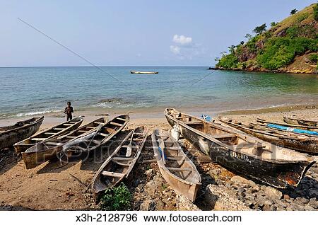 Stock Photograph - pirogues on the beach of Morro Peixe, fishermen village on the north coast of Sao Tome Island, Republic of Sao Tome and Principe, Africa.. Fotosearch