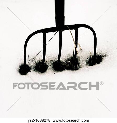Stock Photo - Pitchfork in snow. Fotosearch