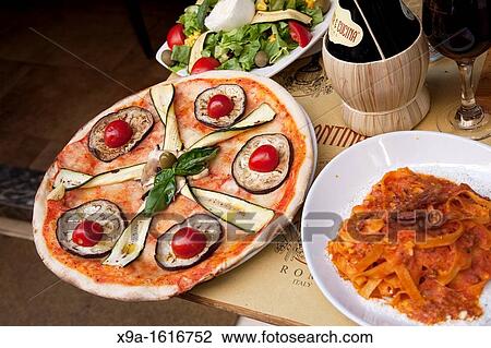 Pizza and Pasta with Wine on Table in Restaurant in Rome View Large Photo Image Stock Image - Pizza and Pasta with Wine on Table in Restaurant in Rome. Fotosearch