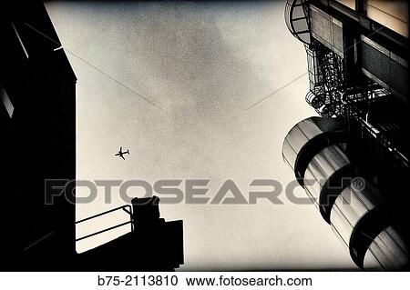 Plane in the sky seen between two buildings in central London. Lloyd's Bank. City of London, England, UK, Europe. View Large Photo Image Stock Image - Plane in the sky seen between two buildings in central London. Lloyd's Bank. City of London, England, UK, Europe.. Fotosearch