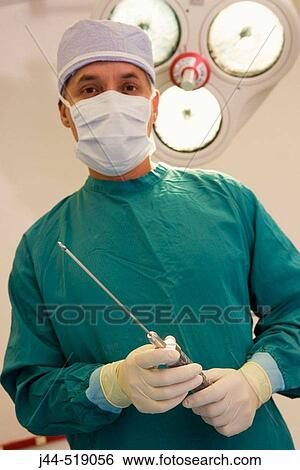 Plastic surgeon with liposuction apparatus in surgery room. View Large Photo Image Stock Photograph - Plastic surgeon with liposuction apparatus in surgery room.. Fotosearch