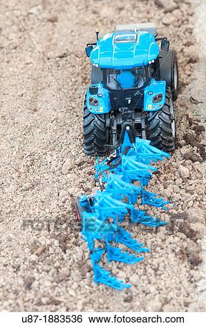 Plastic Toy Tractor Plowing on Field View Large Photo Image Stock Photograph - Plastic Toy Tractor Plowing on Field. Fotosearch