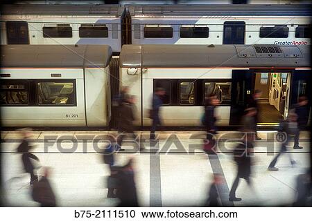 Stock Image - Platform with trains and unrecognizable people in movement at Liverpol street station. London, England, UK, Europe.. Fotosearch