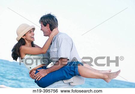 Stock Photograph - playful couple at the beach. Fotosearch