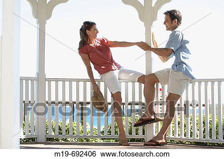 Playful couple dancing in a Gazebo View Large Photo Image Stock Photograph - Playful couple dancing in a Gazebo. Fotosearch